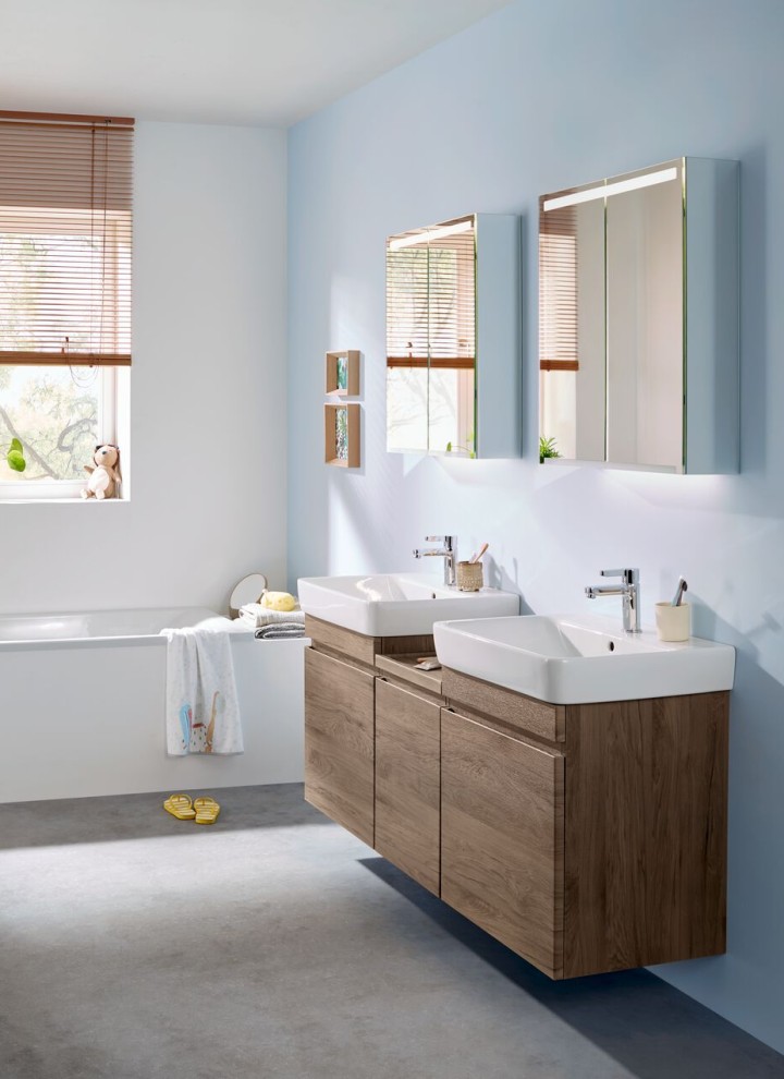 Baño Geberit con dos lavabos que incluye muebles en nogal